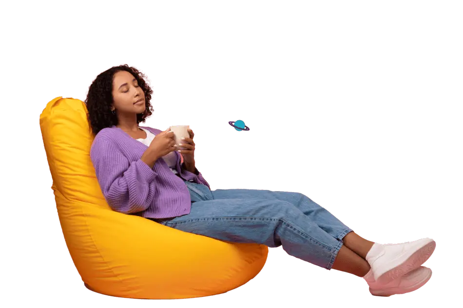 Person relaxing on sofa with a cup of drink.